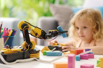 Child playing with a robotic arm toy
