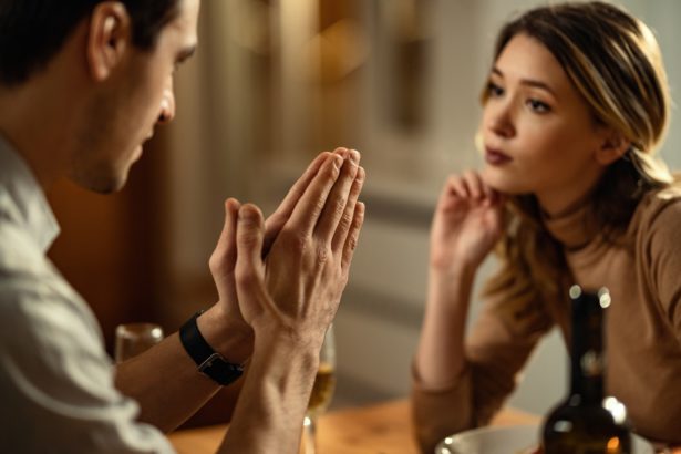 Close-up of man begging his girlfriend for forgiveness.