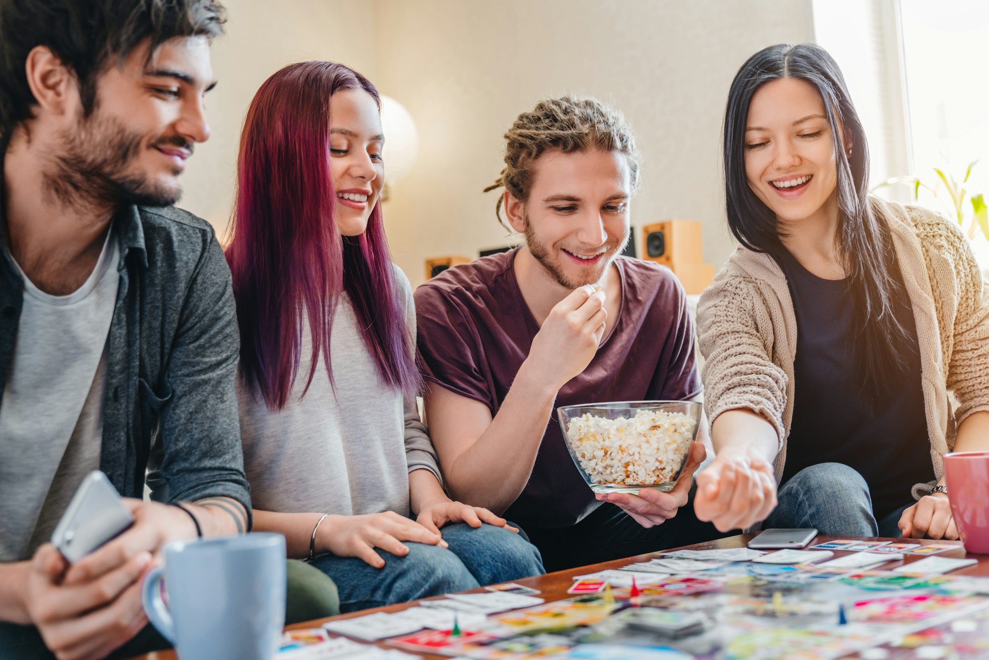 Few happy friends playing in table games indoor
