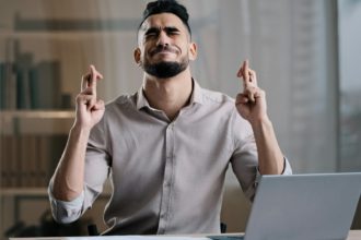 Frustrated hispanic young guy business man in office sadness accountant stressed about bank loan