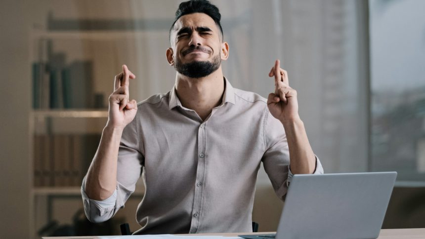 Frustrated hispanic young guy business man in office sadness accountant stressed about bank loan