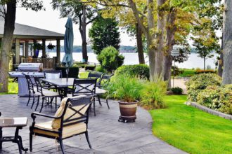 Patio outdoor living space on the lake with beautiful landscape design