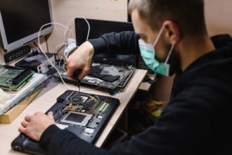 Technician repairing a laptop in the lab. Concept of repair computer, electronic, upgrade, techn