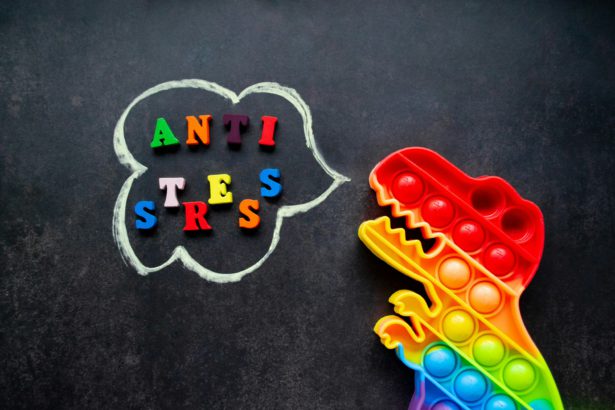 Toy pop it dinosaur rainbow colors. Multicolored letters, inscription-Anti-stress in a speech bubble