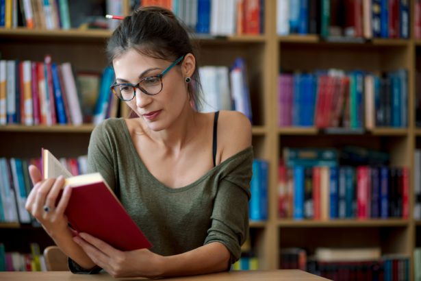 Young beautiful woman reading inspired book
